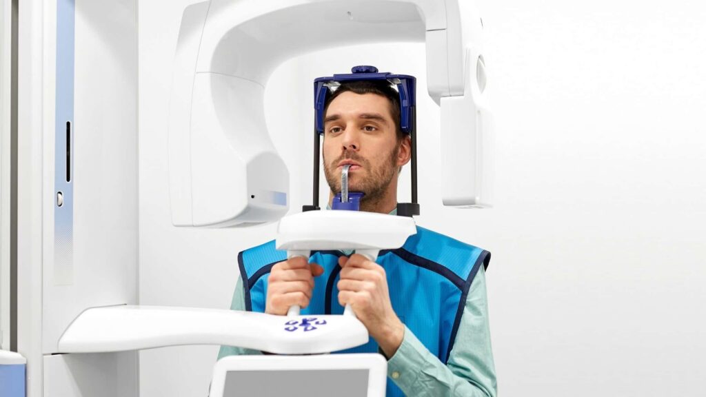 A patient during a panoramic dental X-ray procedure.