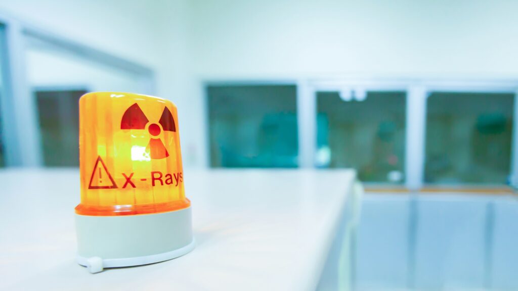 A flashing light to indicate active radiation from an X-ray.