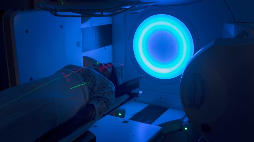 A woman receives radiation therapy treatment for cancer.