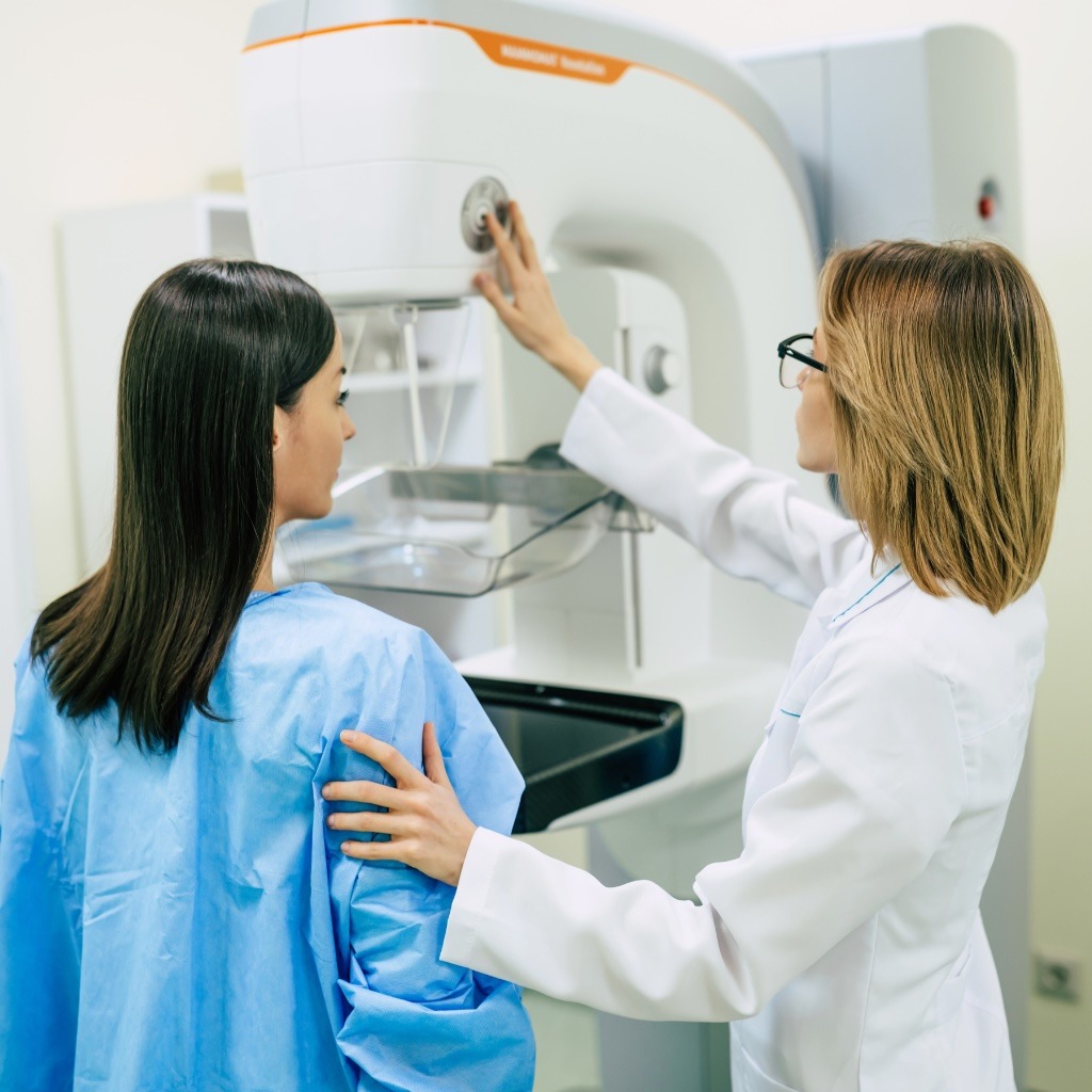 A healthcare worker completes a mammogram.