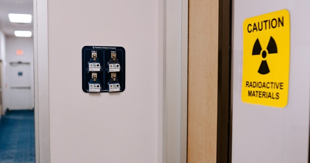 Area badges outside of a room with radioactive materials.