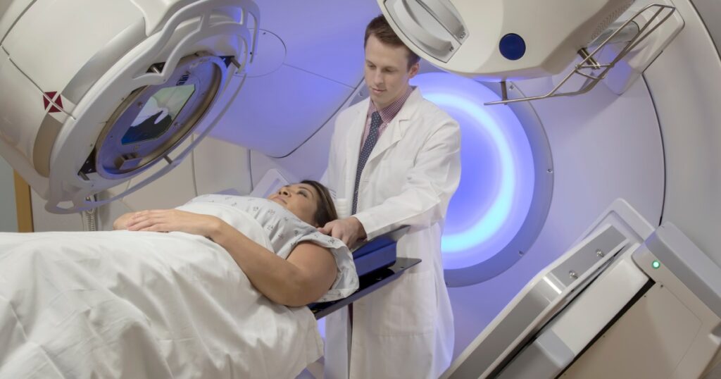 A doctor prepares a patient to receive radiation therapy treatments for cancer.