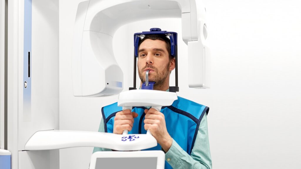 A patient wears a lead apron during a dental X-ray.