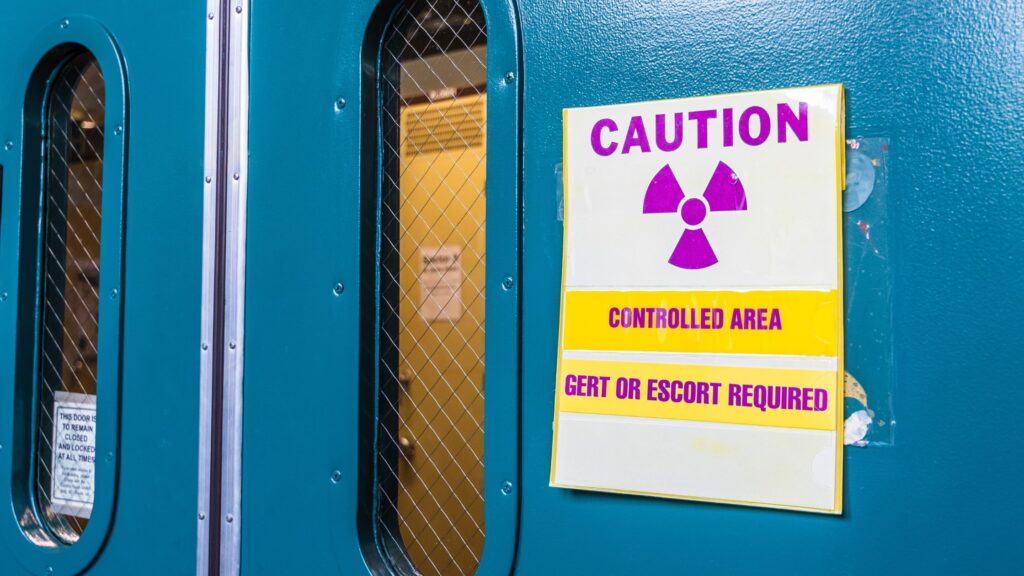 A caution sign outside of an active radiation controlled imaging area.