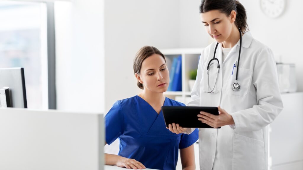 A doctor and a nurse discuss dosimetry service options.