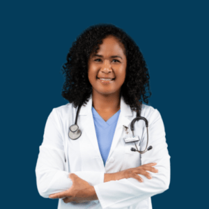 A medical doctor smiles while wearing a white coat and a stethoscope.