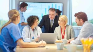 Medical professionals discussing data presentation.