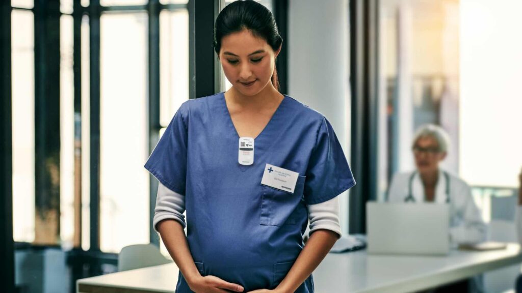 Pregnant healthcare worker in scrubs.