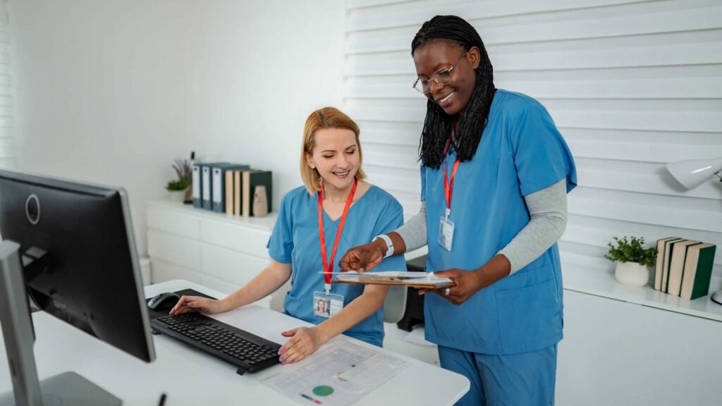 Two employees review simplified radiation Form 5 printed from their MyRadCare™ customer account.