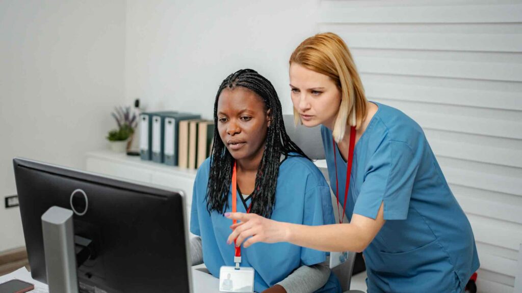 Two employees review radiation Form 5 on their customer account.