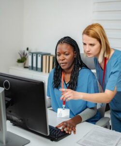 Two employees review radiation Form 5 on their customer account.