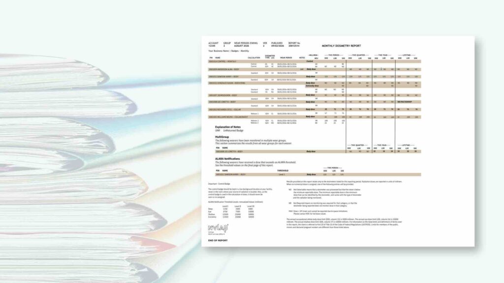 A stack of files and a monthly dosimetry report example.