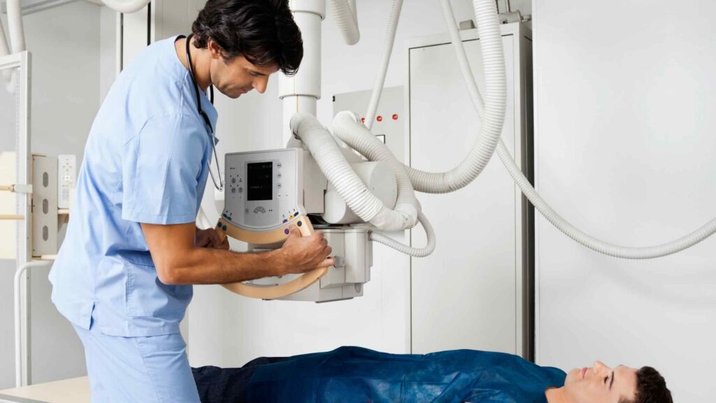 A radiologic technologist prepares a patient for an imaging procedure.