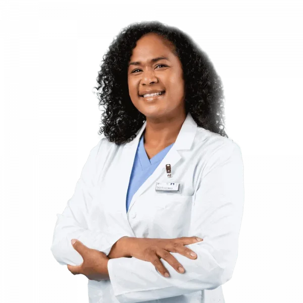 Healthcare worker wearing a personal dosimeter badge on a white coat for hospital radiation monitoring.