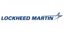 Logo of Lockheed Martin in blue letters on a white background, featuring a stylized star with three trailing lines on the right.